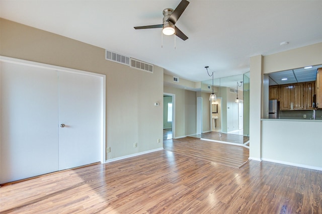 2213 S Braeswood Blvd Unit 13C, Houston, TX 77030 - unfurnished living room with light wood-style flooring and a ceiling fan