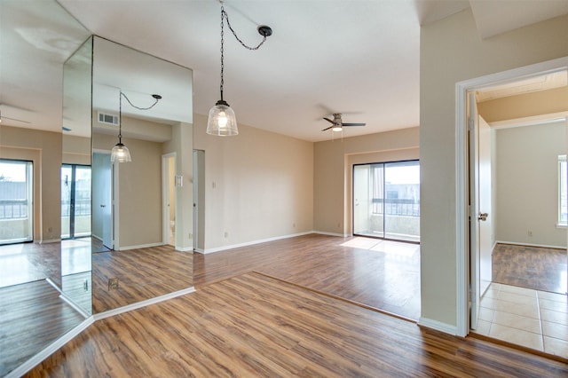 2213 S Braeswood Blvd Unit 13C, Houston, TX 77030 - unfurnished room featuring healthy amount of natural light, wood finished floors, and a ceiling fan