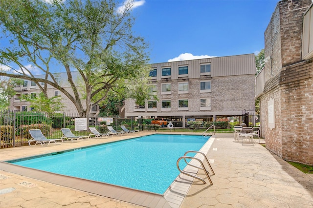 2213 S Braeswood Blvd Unit 13C, Houston, TX 77030 - community pool featuring a patio area
