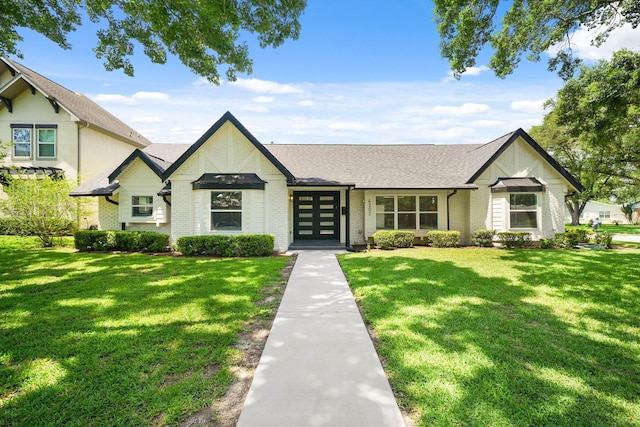 4302 Wigton Dr, Houston, TX 77096 - view of front of home featuring a front lawn, brick siding, a shingled roof, and french doors