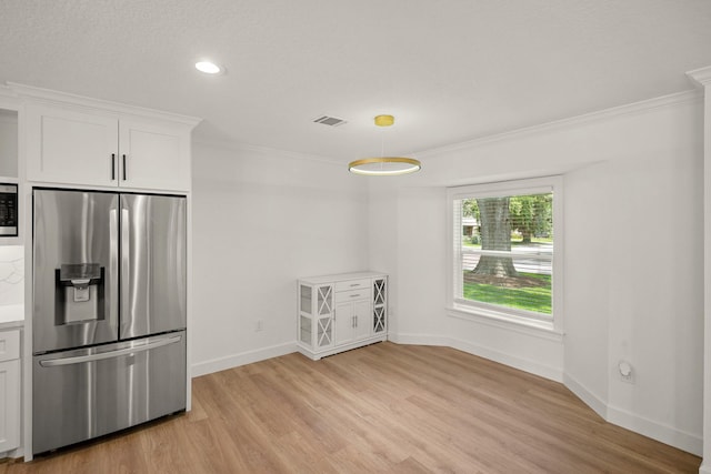 4302 Wigton Dr, Houston, TX 77096 - kitchen with appliances with stainless steel finishes, crown molding, light wood-type flooring, white cabinets, and light countertops