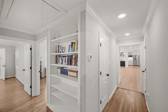 4302 Wigton Dr, Houston, TX 77096 - hallway with attic access, ornamental molding, light wood-style flooring, recessed lighting, and built in features