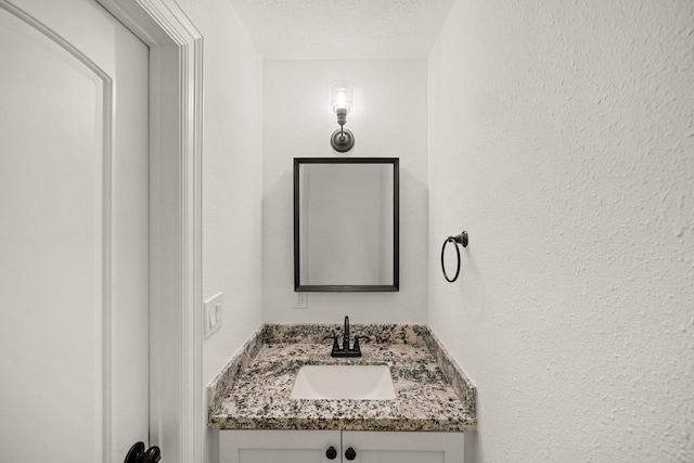 4302 Wigton Dr, Houston, TX 77096 - bathroom featuring vanity, a textured ceiling, and a textured wall