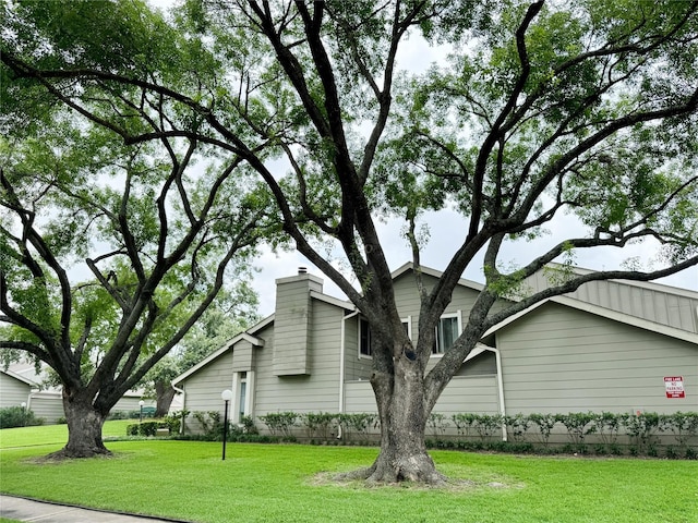 12991 Wirevine Ln, Houston, TX 77072 - view of property exterior featuring a lawn and a chimney