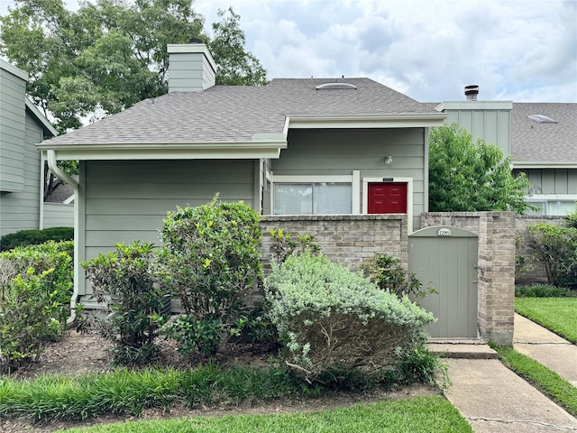 12991 Wirevine Ln, Houston, TX 77072 - view of front facade with a chimney and a shingled roof