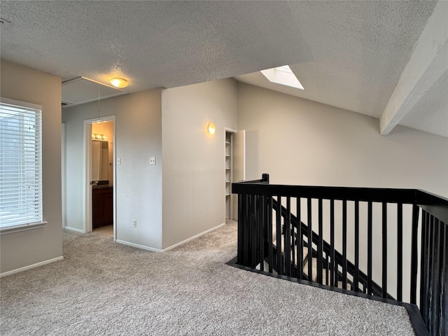 12991 Wirevine Ln, Houston, TX 77072 - hall with attic access, an upstairs landing, a textured ceiling, carpet, and lofted ceiling