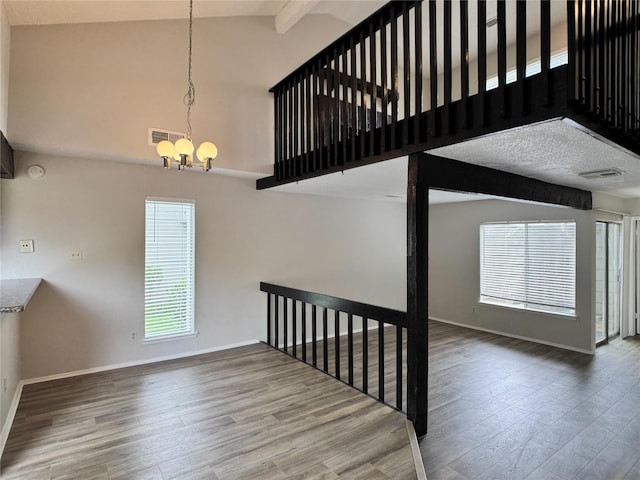 12991 Wirevine Ln, Houston, TX 77072 - staircase featuring a chandelier, wood finished floors, plenty of natural light, beamed ceiling, and high vaulted ceiling