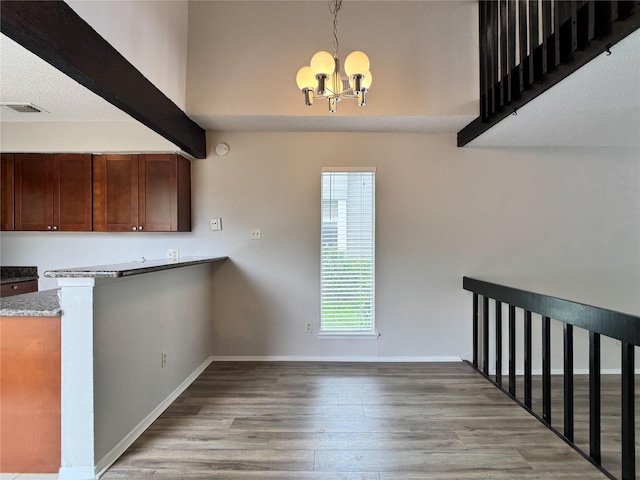 12991 Wirevine Ln, Houston, TX 77072 - unfurnished dining area featuring a chandelier, wood finished floors, and beamed ceiling