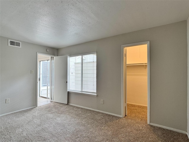 12991 Wirevine Ln, Houston, TX 77072 - unfurnished bedroom with carpet, a spacious closet, and a textured ceiling