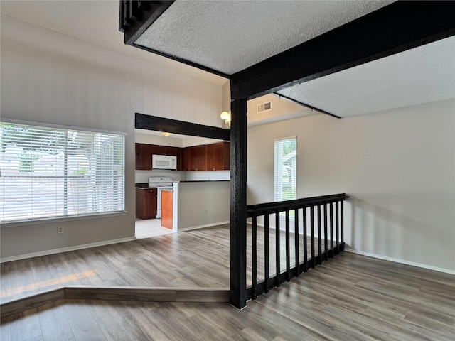 12991 Wirevine Ln, Houston, TX 77072 - stairway featuring wood finished floors and a textured ceiling