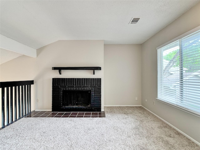 12991 Wirevine Ln, Houston, TX 77072 - unfurnished living room with carpet, lofted ceiling, a brick fireplace, and a textured ceiling