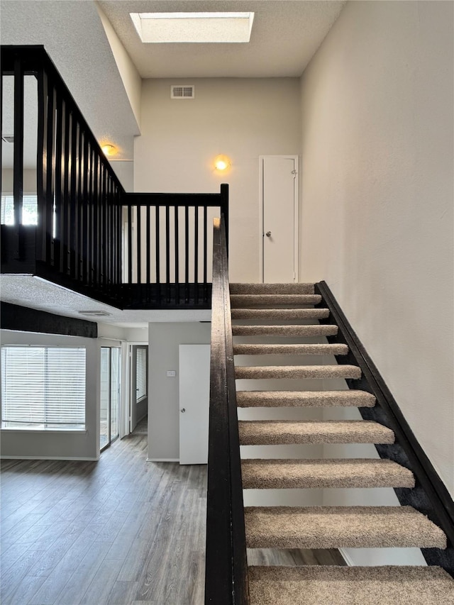12991 Wirevine Ln, Houston, TX 77072 - stairs with a skylight and wood finished floors