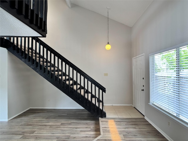12991 Wirevine Ln, Houston, TX 77072 - entryway with high vaulted ceiling, stairway, and wood finished floors