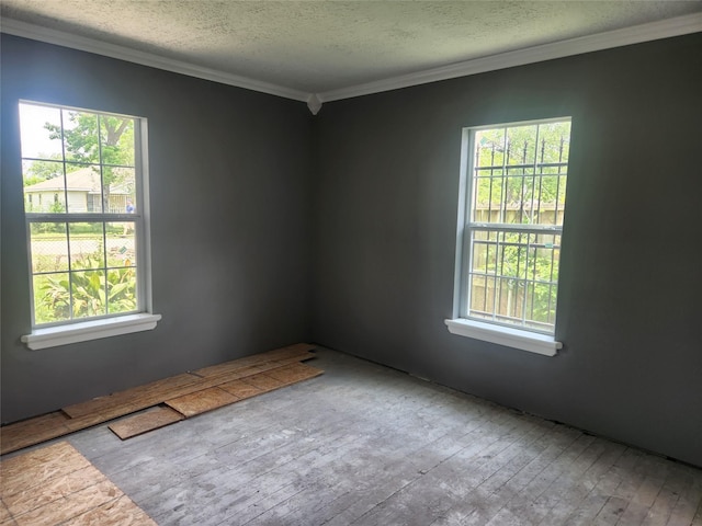 2926 Wimberly St, Houston, TX 77093 - spare room with hardwood / wood-style flooring, crown molding, healthy amount of natural light, and a textured ceiling