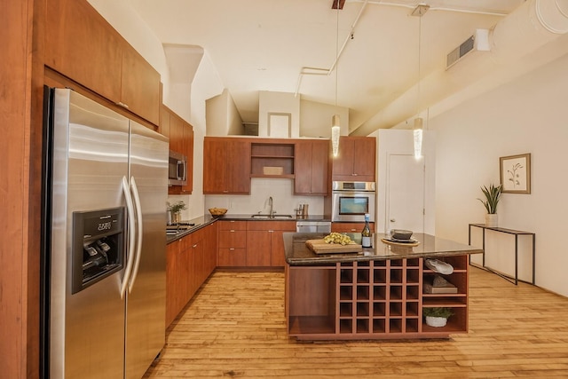 705 Main St Unit 302, Houston, TX 77002 - kitchen featuring stainless steel appliances, open shelves, dark countertops, light wood-type flooring, and a center island