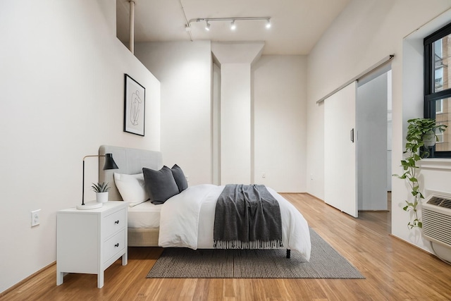 705 Main St Unit 302, Houston, TX 77002 - bedroom with track lighting and light wood-type flooring