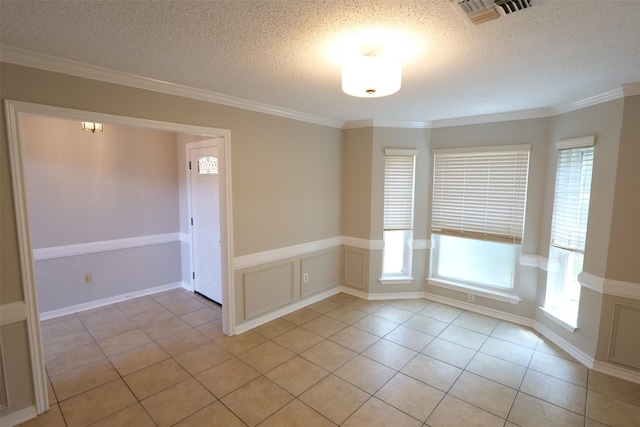 20246 Pittsford Dr, Katy, TX 77450 - empty room with light tile patterned floors, a textured ceiling, and crown molding