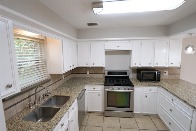 20246 Pittsford Dr, Katy, TX 77450 - kitchen featuring appliances with stainless steel finishes, decorative backsplash, and white cabinets