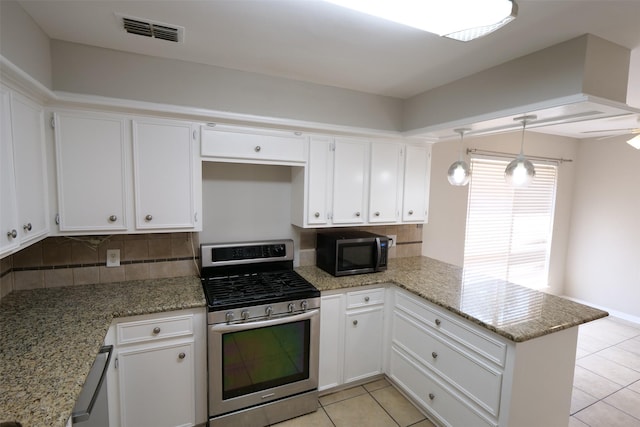 20246 Pittsford Dr, Katy, TX 77450 - kitchen with stainless steel gas stove, black microwave, a peninsula, and tasteful backsplash