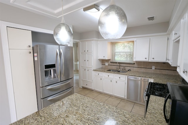 20246 Pittsford Dr, Katy, TX 77450 - kitchen with appliances with stainless steel finishes, backsplash, light tile patterned floors, and white cabinets