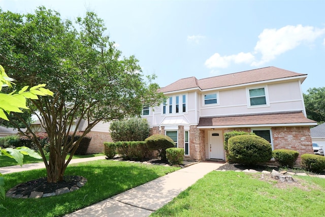 20246 Pittsford Dr, Katy, TX 77450 - view of front facade with brick siding, a front lawn, and a shingled roof