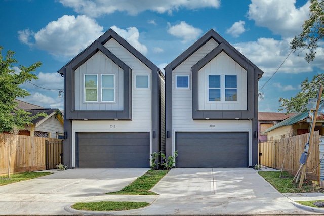 3310 Bremond St, Houston, TX 77004 - view of front of home with board and batten siding, a garage, and driveway