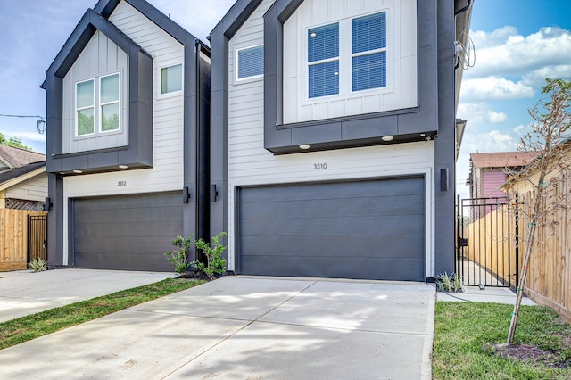 3310 Bremond St, Houston, TX 77004 - view of front of home with board and batten siding, an attached garage, and concrete driveway