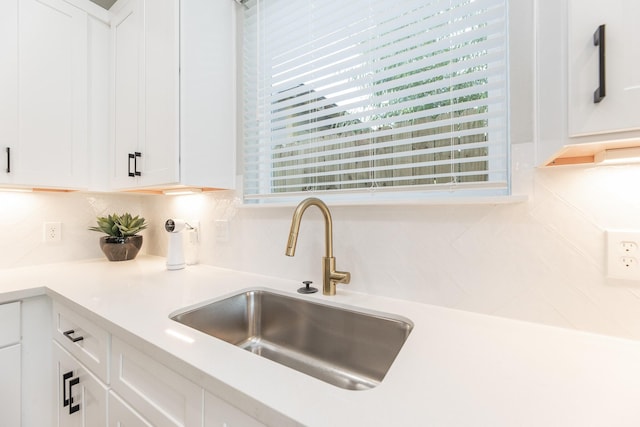 3310 Bremond St, Houston, TX 77004 - kitchen featuring white cabinets, light countertops, and decorative backsplash