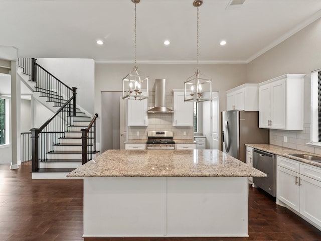 3303 Beverly Forest Dr, Houston, TX 77057 - kitchen featuring wall chimney exhaust hood, stainless steel appliances, a center island, a chandelier, and decorative backsplash