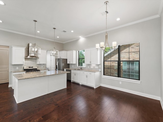3303 Beverly Forest Dr, Houston, TX 77057 - kitchen with stainless steel appliances, wall chimney exhaust hood, tasteful backsplash, a center island, and white cabinetry