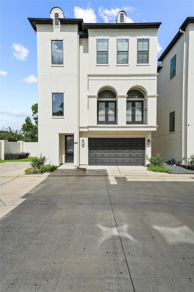 3303 Beverly Forest Dr, Houston, TX 77057 - view of front of home with stucco siding, driveway, a garage, and a balcony