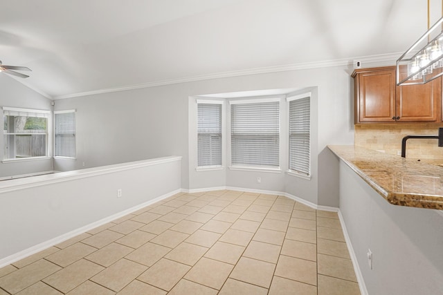 17919 Eagle Pass Falls Ct, Humble, TX 77346 - unfurnished dining area with ceiling fan, light tile patterned floors, lofted ceiling, and crown molding