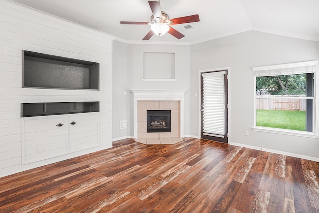 17919 Eagle Pass Falls Ct, Humble, TX 77346 - unfurnished living room featuring wood finished floors, a tile fireplace, ceiling fan, ornamental molding, and lofted ceiling