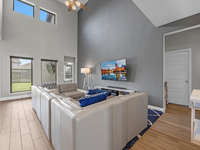 23027 Needlegrass Rd, Katy, TX 77493 - living room with high vaulted ceiling, ceiling fan, light wood-type flooring, and healthy amount of natural light