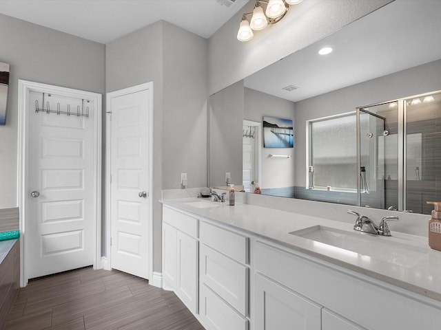 23027 Needlegrass Rd, Katy, TX 77493 - full bath with double vanity, a stall shower, and wood finished floors