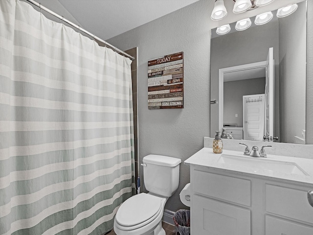 23027 Needlegrass Rd, Katy, TX 77493 - full bathroom with a textured wall, vanity, vaulted ceiling, and a shower with curtain
