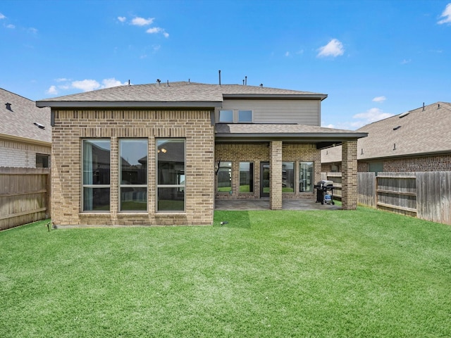 23027 Needlegrass Rd, Katy, TX 77493 - back of property featuring brick siding, a fenced backyard, and a patio