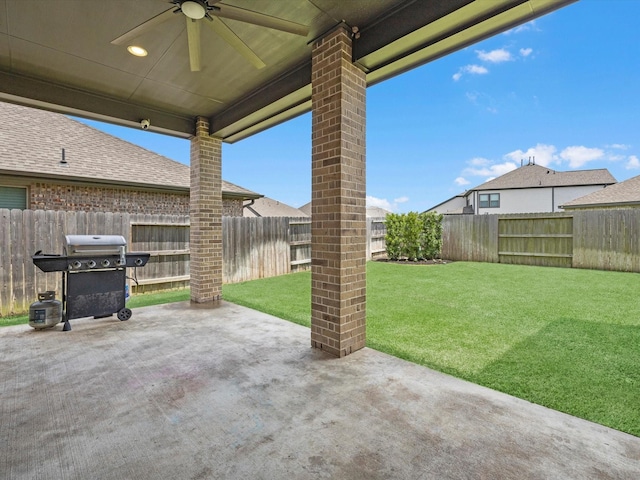 23027 Needlegrass Rd, Katy, TX 77493 - fenced backyard featuring a ceiling fan, a patio, and a grill