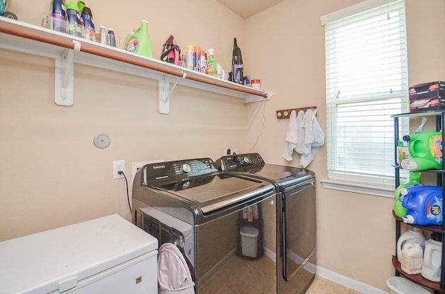 6215 Carnaby Ln, Rosenberg, TX 77471 - washroom with washing machine and clothes dryer and light tile patterned flooring
