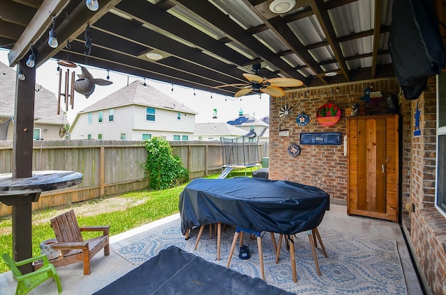 6215 Carnaby Ln, Rosenberg, TX 77471 - fenced backyard featuring a ceiling fan, a patio area, and area for grilling