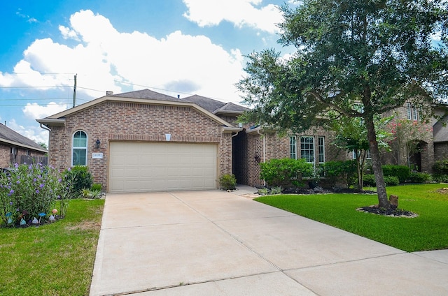 6215 Carnaby Ln, Rosenberg, TX 77471 - view of front facade with an attached garage, brick siding, driveway, and a front lawn