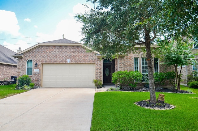 6215 Carnaby Ln, Rosenberg, TX 77471 - ranch-style home with a garage, driveway, brick siding, and a front lawn