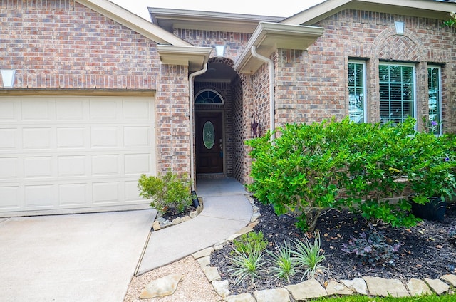 6215 Carnaby Ln, Rosenberg, TX 77471 - entrance to property with an attached garage, brick siding, and driveway