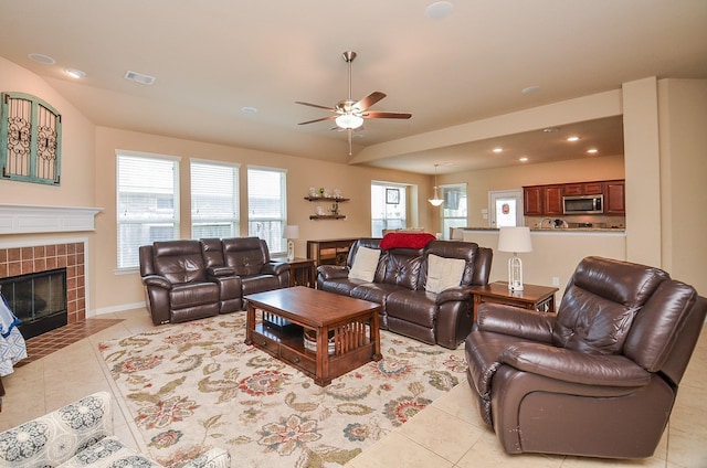 6215 Carnaby Ln, Rosenberg, TX 77471 - living room featuring light tile patterned flooring, a tiled fireplace, a ceiling fan, and recessed lighting