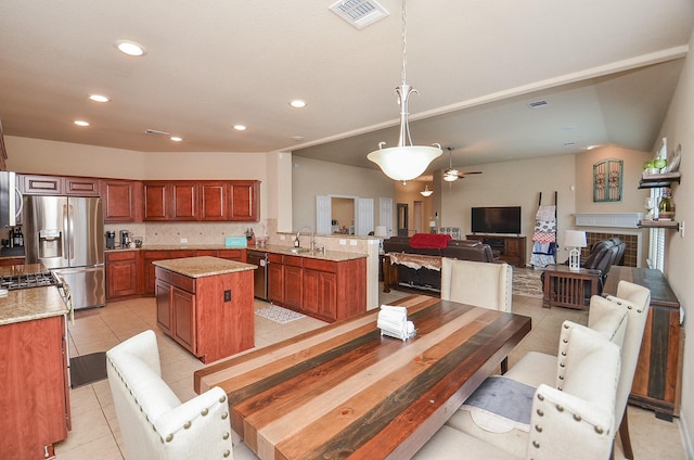 6215 Carnaby Ln, Rosenberg, TX 77471 - dining area featuring recessed lighting, light tile patterned floors, ceiling fan, and a tiled fireplace
