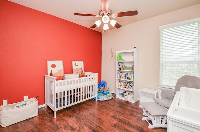 6215 Carnaby Ln, Rosenberg, TX 77471 - bedroom with multiple windows, wood finished floors, a crib, and a ceiling fan