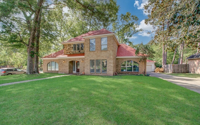 5422 Windy Lake Dr, Houston, TX 77345 - mediterranean / spanish house with a tile roof, driveway, and an attached garage