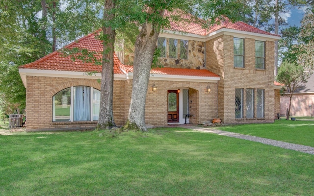 5422 Windy Lake Dr, Houston, TX 77345 - mediterranean / spanish-style house featuring a front lawn, a tile roof, and a porch