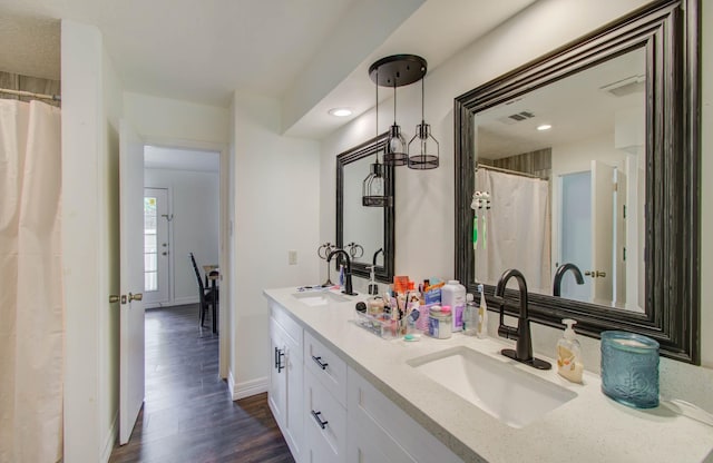 5422 Windy Lake Dr, Houston, TX 77345 - bathroom with double vanity, wood finished floors, a shower with shower curtain, and recessed lighting