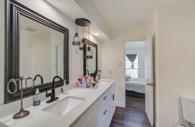 5422 Windy Lake Dr, Houston, TX 77345 - bathroom featuring wood finished floors, double vanity, and ensuite bathroom